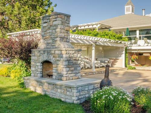 Beautiful Stone Outdoor Fireplace in a Backyard