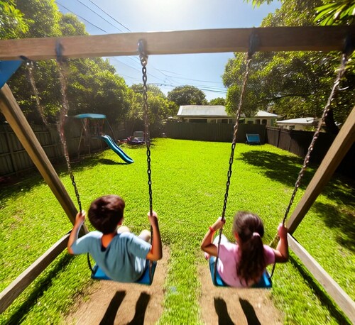 Children Playing on Backyard Swings in the Sun